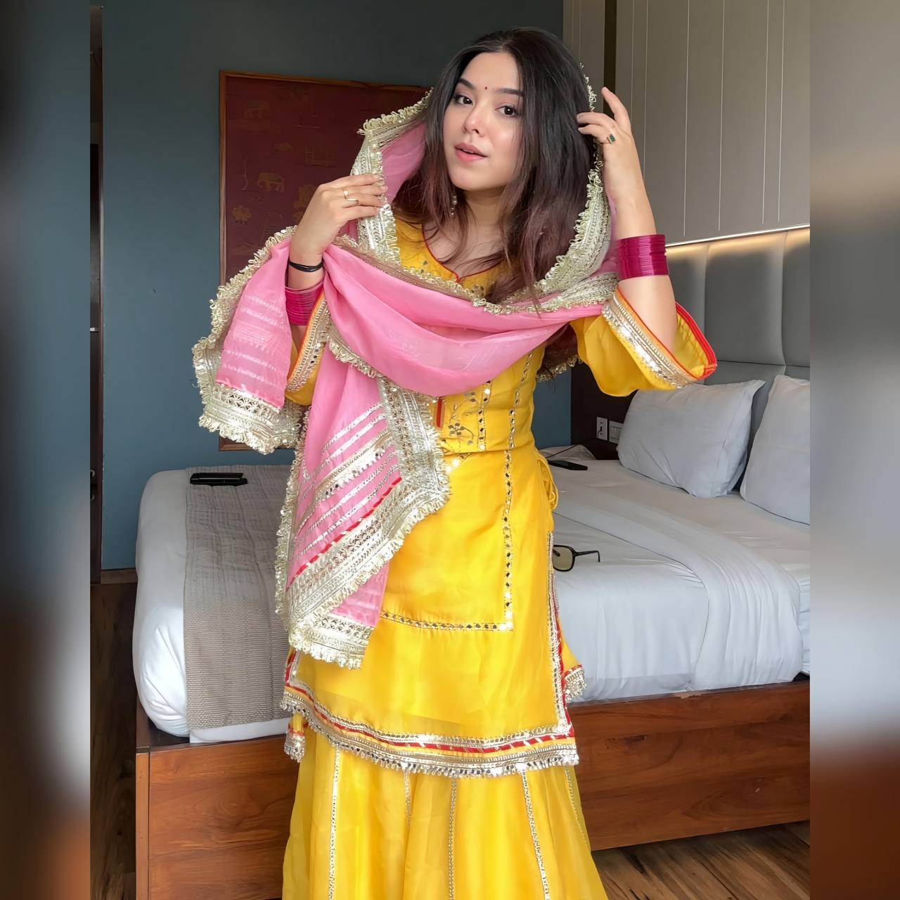 "Stylish woman wearing a vibrant yellow sharara suit with silver gota patti work and contrasting pink dupatta – festive Indian ethnic outfit for women."
"Yellow sharara suit for women with mirror and gota patti embroidery, paired with pink dupatta – ethnic wear for festivals and weddings"

"Designer yellow sharara set with detailed embroidery and pink dupatta – perfect for haldi, mehendi, and festive celebrations"
"Yellow sharara suit with pink dupatta – festive ethnic wear for women"



