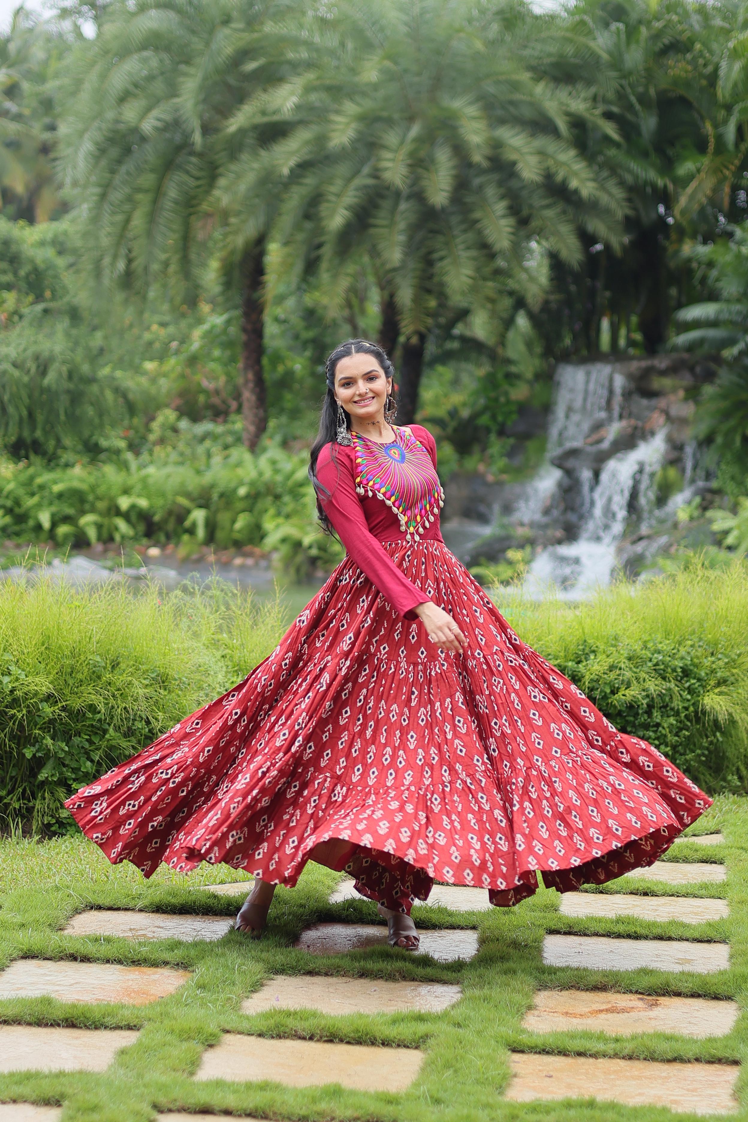 Traditional Wear Printed Cotton With Kutchi Gamthi Work And 12 Meter Flair Maroon Color Navratri Gown