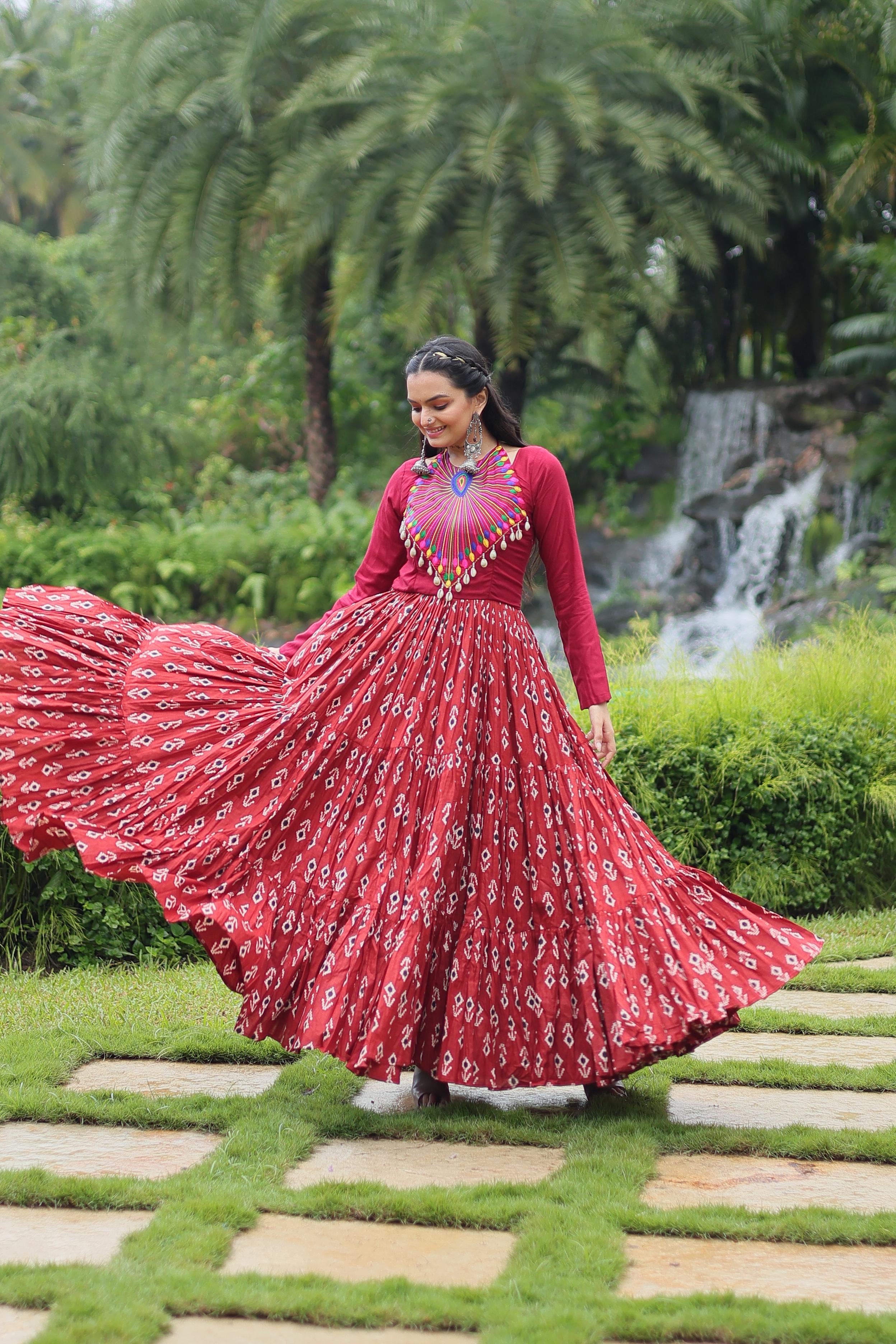 Traditional Wear Printed Cotton With Kutchi Gamthi Work And 12 Meter Flair Maroon Color Navratri Gown