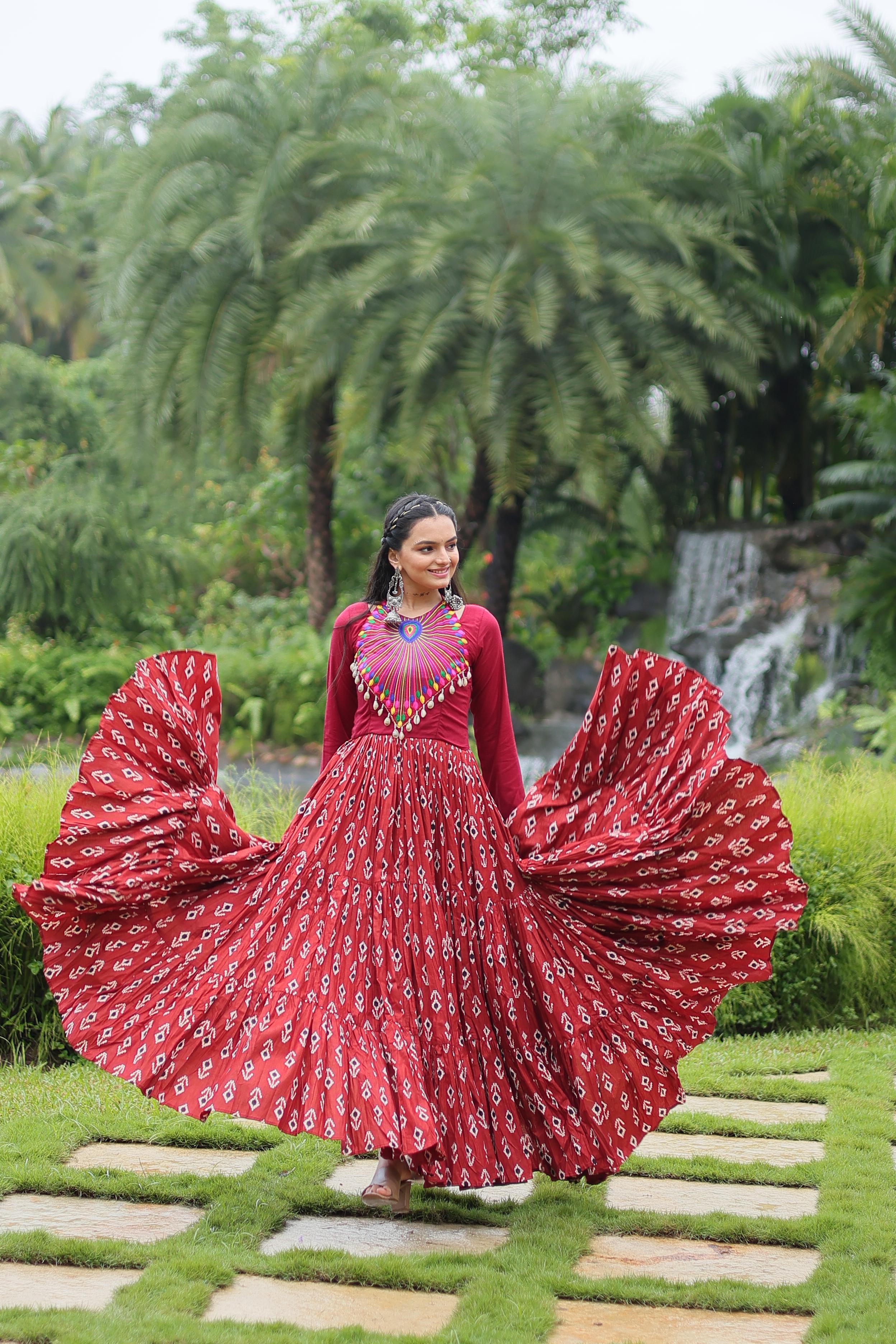 Traditional Wear Printed Cotton With Kutchi Gamthi Work And 12 Meter Flair Maroon Color Navratri Gown