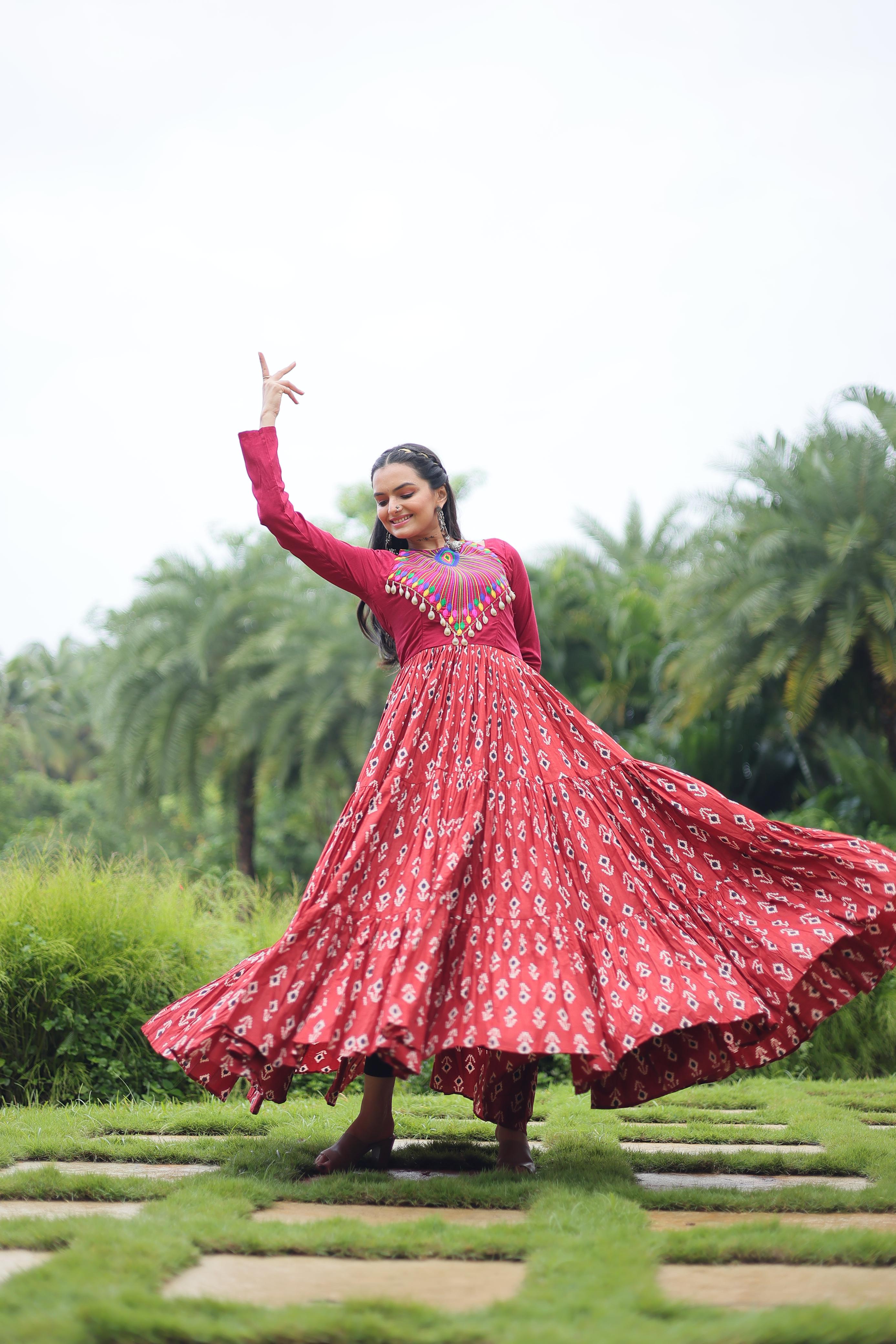 Traditional Wear Printed Cotton With Kutchi Gamthi Work And 12 Meter Flair Maroon Color Navratri Gown