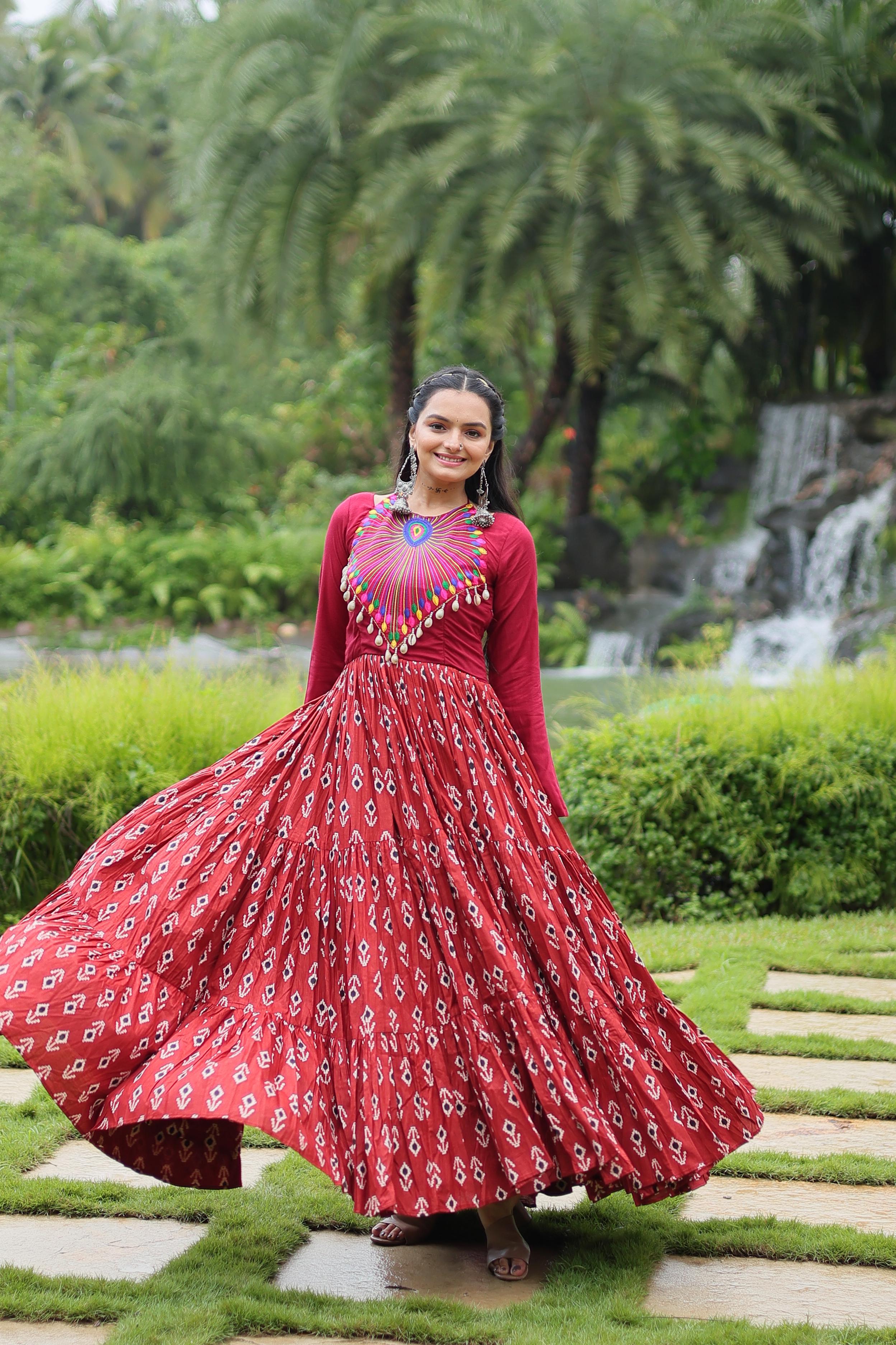 Traditional Wear Printed Cotton With Kutchi Gamthi Work And 12 Meter Flair Maroon Color Navratri Gown