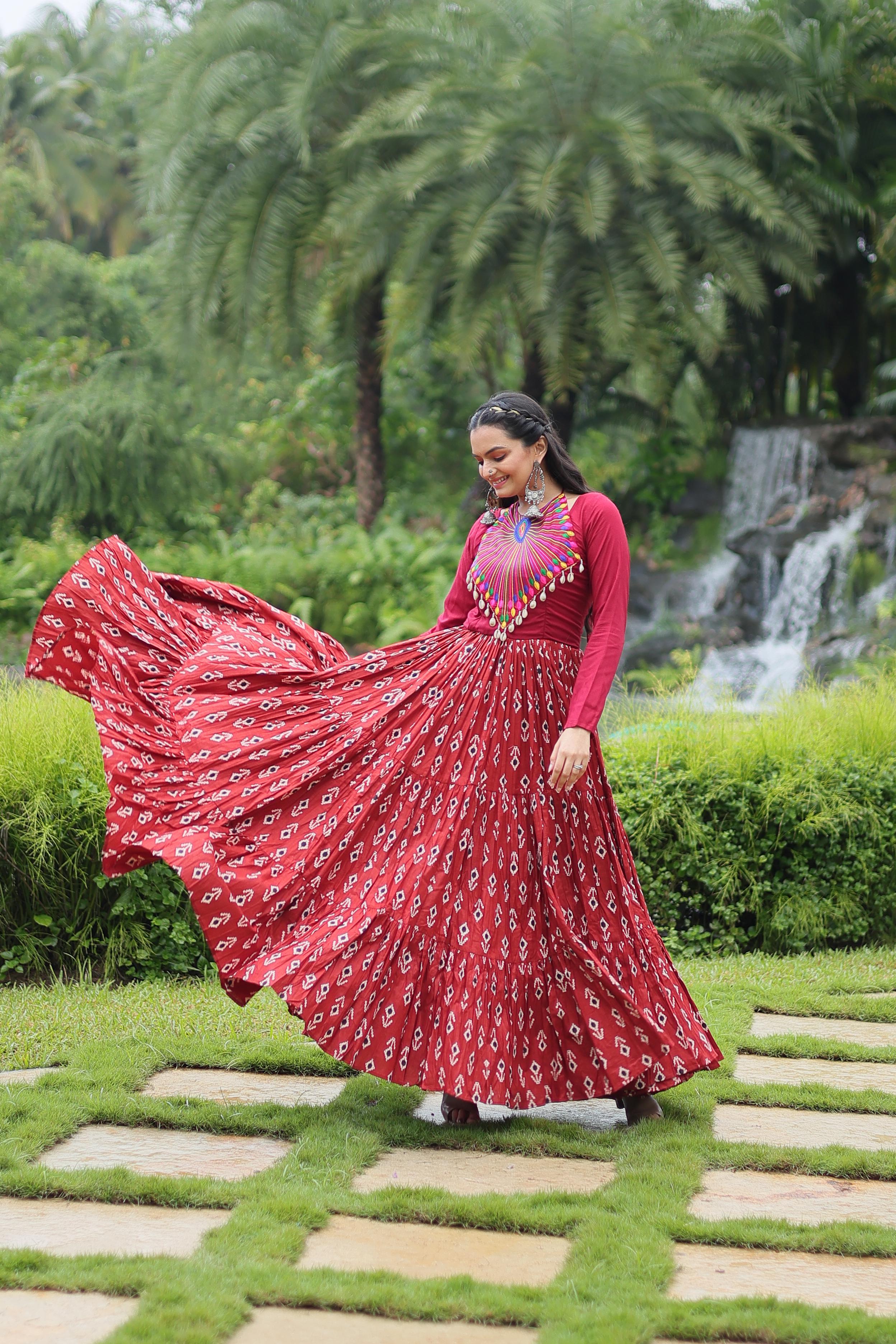 Traditional Wear Printed Cotton With Kutchi Gamthi Work And 12 Meter Flair Maroon Color Navratri Gown