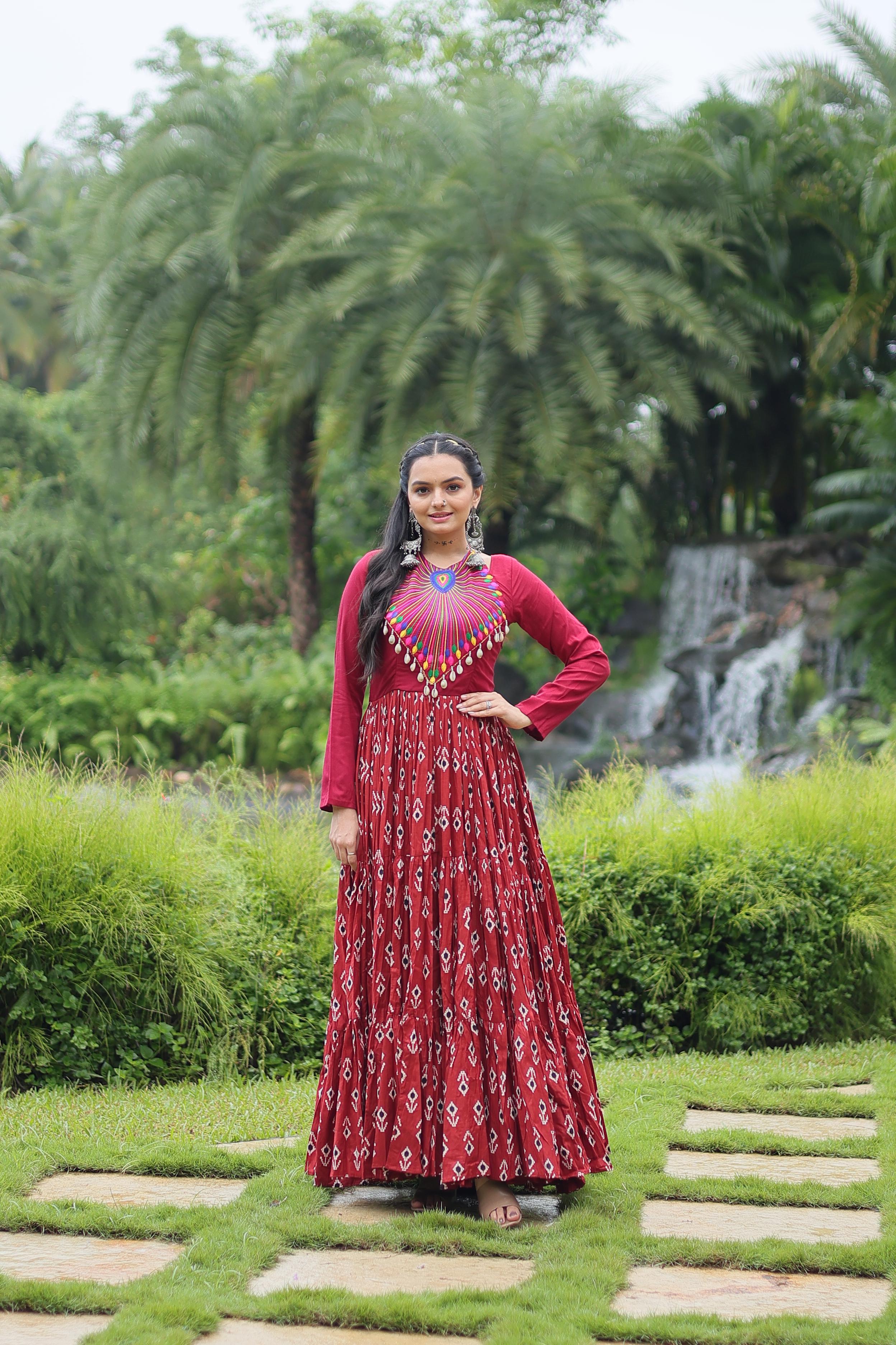 Traditional Wear Printed Cotton With Kutchi Gamthi Work And 12 Meter Flair Maroon Color Navratri Gown