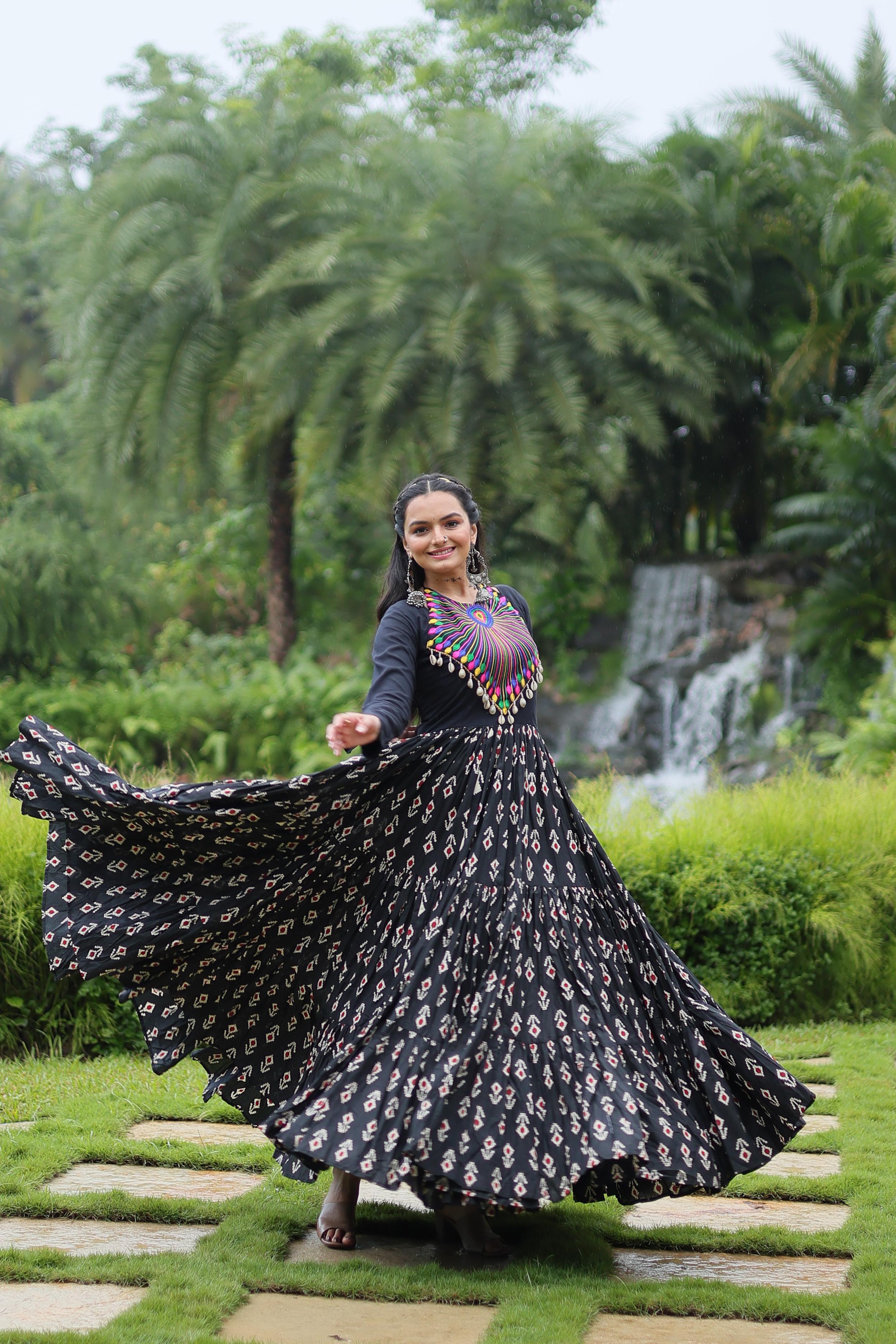 Traditional Wear Printed Cotton With Kutchi Gamthi Work And 12 Meter Flair Black Color Navratri Gown