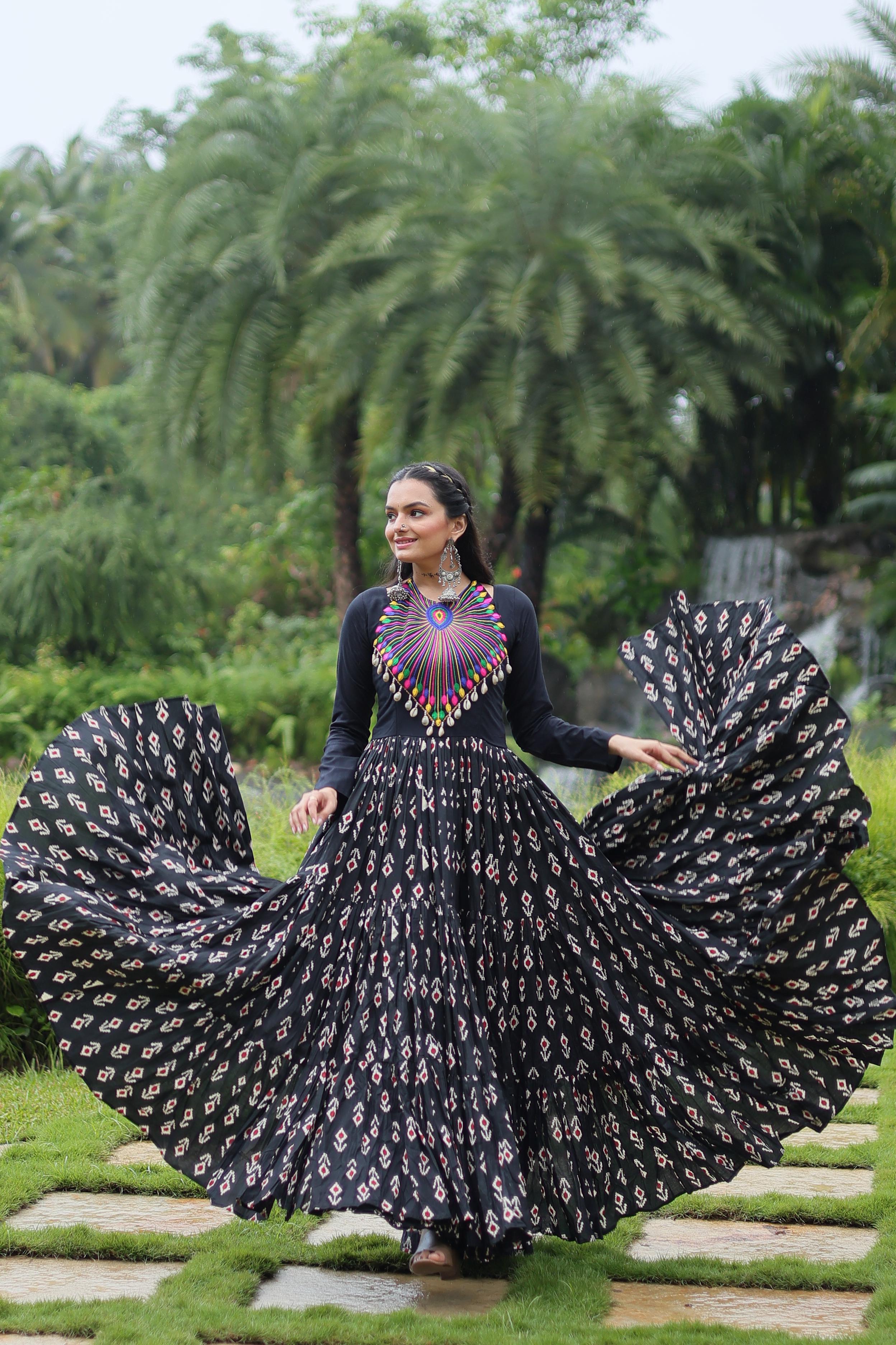 Traditional Wear Printed Cotton With Kutchi Gamthi Work And 12 Meter Flair Black Color Navratri Gown