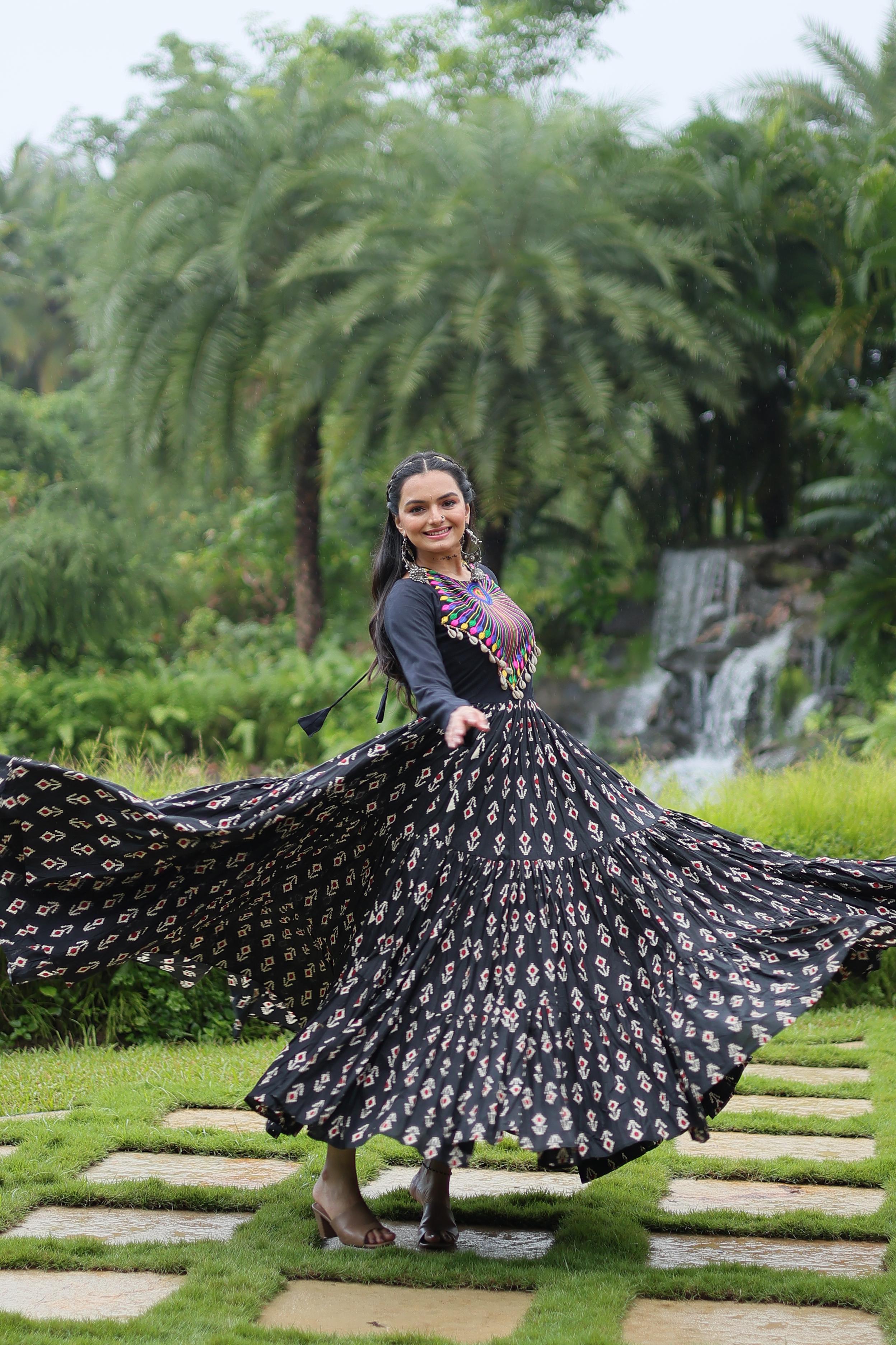 Traditional Wear Printed Cotton With Kutchi Gamthi Work And 12 Meter Flair Black Color Navratri Gown