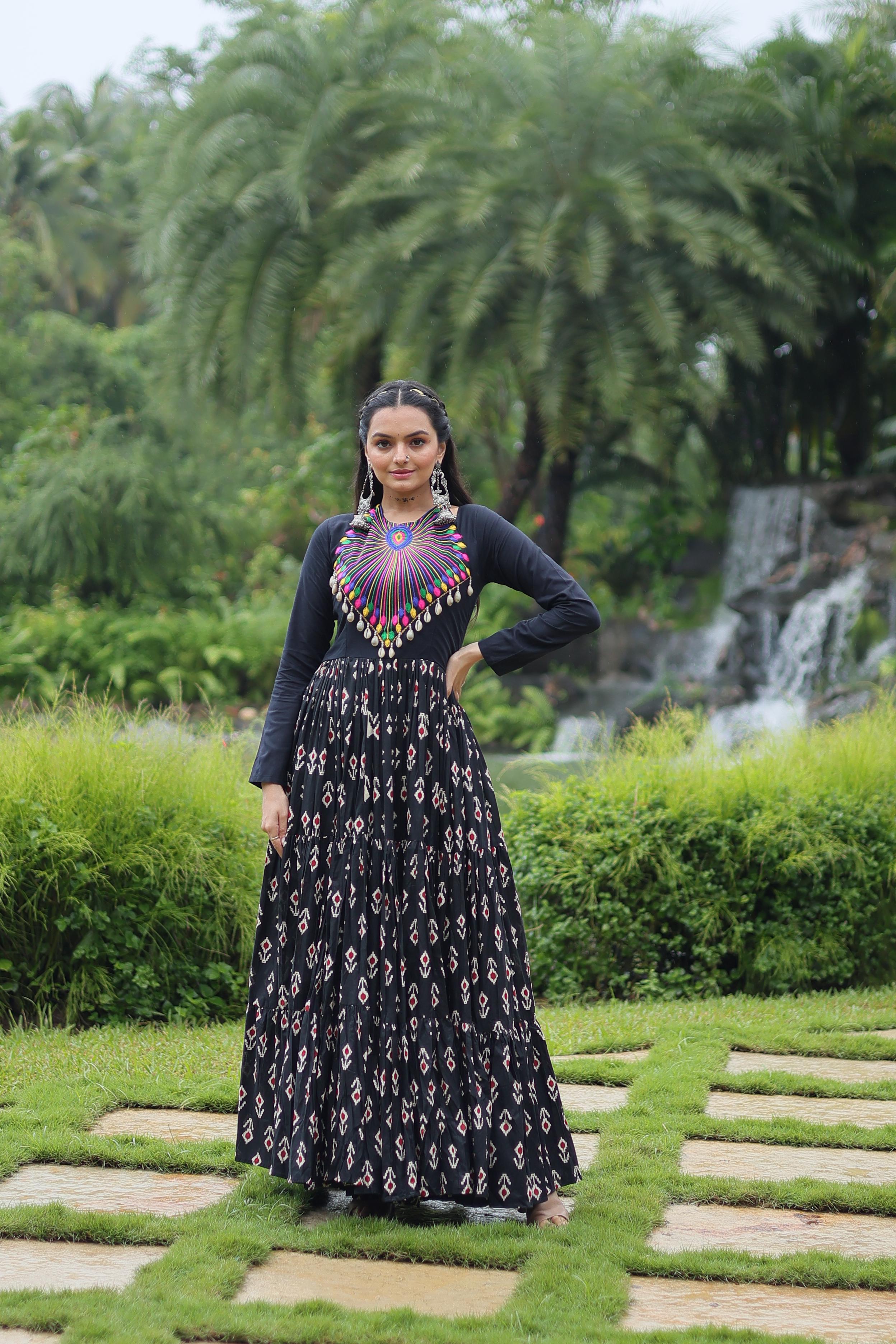 Traditional Wear Printed Cotton With Kutchi Gamthi Work And 12 Meter Flair Black Color Navratri Gown